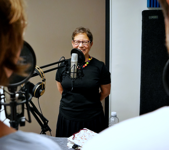 Dr. Irene Berti im Podcast-Studio am Mikrofon 