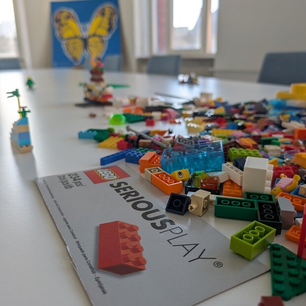 Zu sehen sind Legosteine auf einem Schreibtisch.