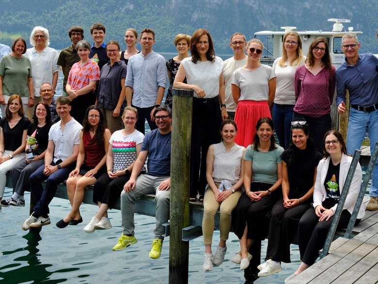 Das Foto zeigt die Teilnehmer und Teilnehmerinnen der Doktorierendentagung 2026 in einem Gruppenfoto am See.