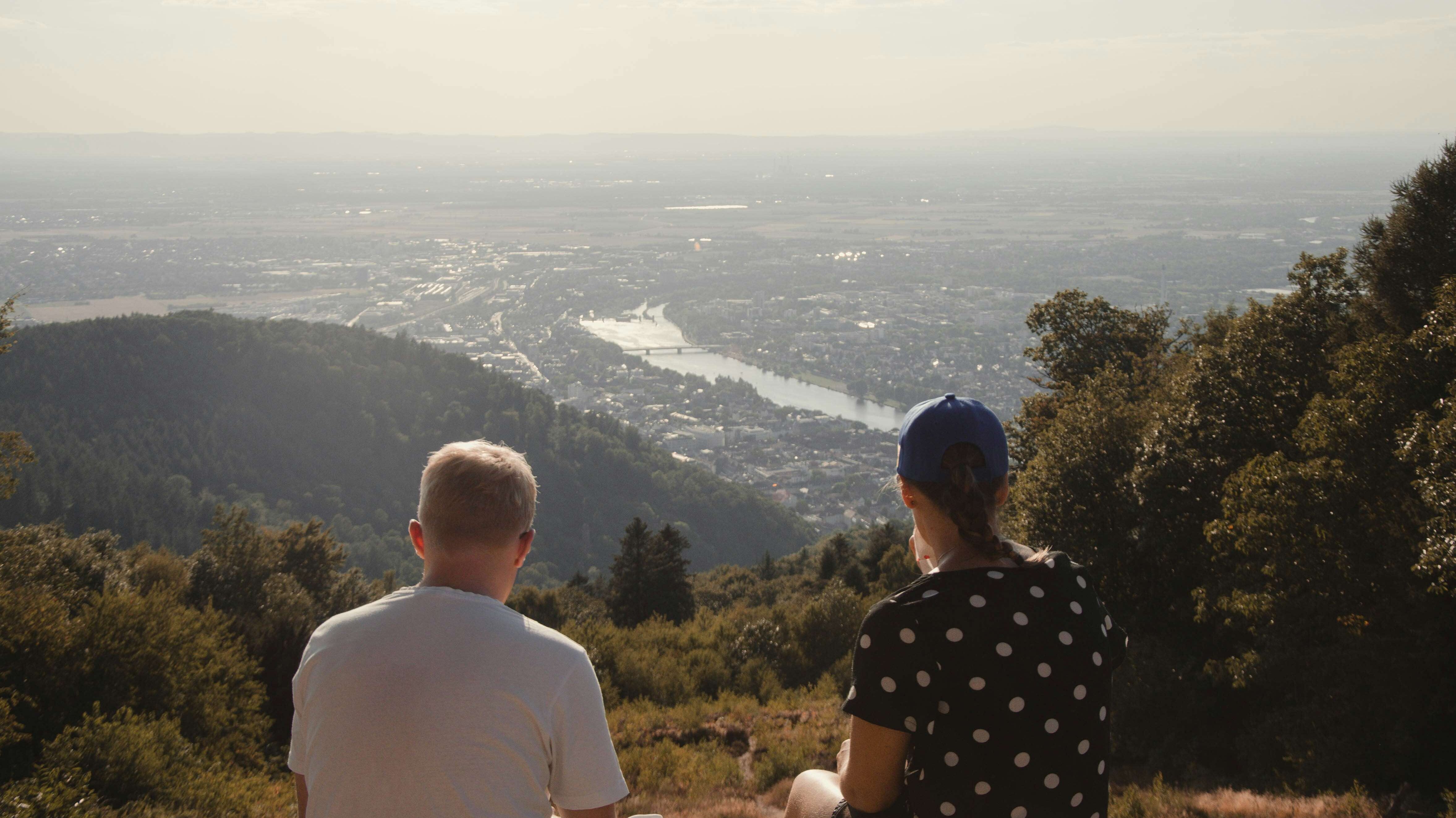 Zu sehen sind zwei Personen, die auf Heidelberg herabblicken.