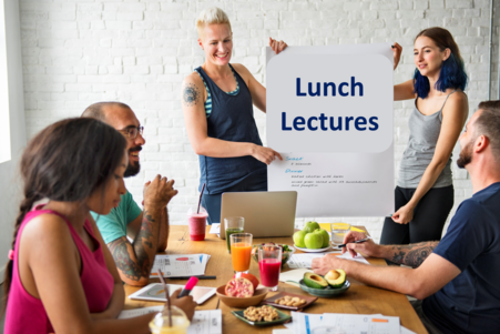 Zwei Personen halten Plakat hoch mit der AUfschrift Lunch Lectures