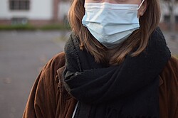 Frau mit einer medizinischen Maske aufgrund der Corona-Pandemie.