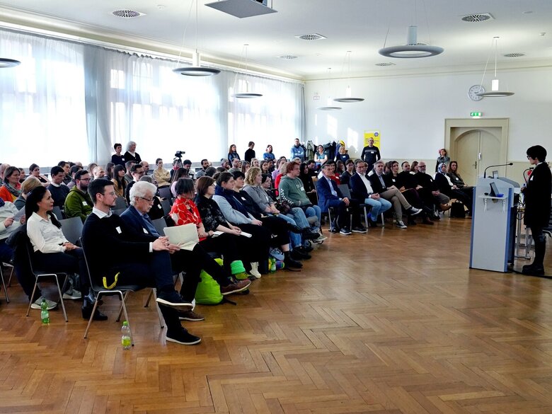 Besucher:innen der Fachtagung "Extremismus und Radikalisierung" sitzen in der Aula der PHHD.