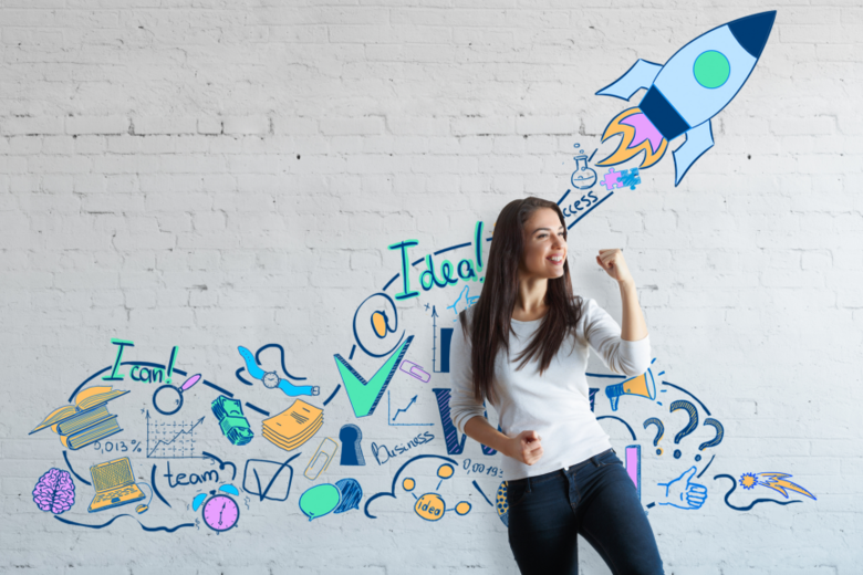 Eine Frau, die vor einer bunten Wand mit positiven Affirmationen, wie bspw. "I can", steht und ihre Faust in einer Gewinnerpose geballt hat. Dies soll verdeutlichen, dass PHeelGood mit den Mentalstrategien zur mentalen Gesundheit beitragen möchte.