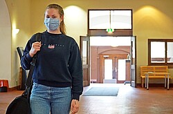 Studentin mit Mund-Nasen-Bedeckung im Eingang des Altbaues der Pädagogischen Hochschule. 