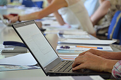 Hands of a person typing on a laptop computer