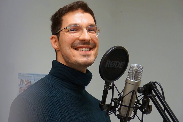 Zu sehen ist Achim Hoffmann am Mikrofon im Podcast-Studio.