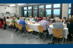 Das Foto zeigt das Generationenübergreifendes Treffen des Freundeskreises an einem langen gedeckten Tisch.
