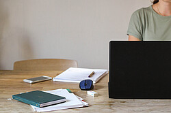 Das Bild zeigt einen Schreibtisch, an dem eine Person mit einem Laptop arbeitet. Copyright Pädagogische Hochschule Heidelberg