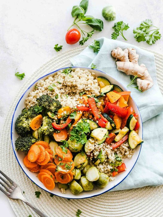 Ein Teller mit viel Gemüse und Hirse.