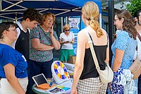 Das Bild zeigt den Stand des AW-ZIB im Rahmen der PH Days. Interessierte Stuudierende stehen vor dem Stand, der von MIigliedern des AW-ZIB und der Fachschaft Sonderpädagogik betreut wird. Auf einem runden Tisch steht ein barrierearmes Glücksrad, das mit einem Buzzer bedient werden kann.